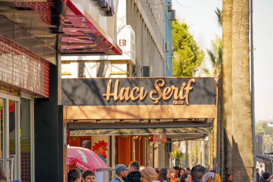 a group of people standing outside of a store