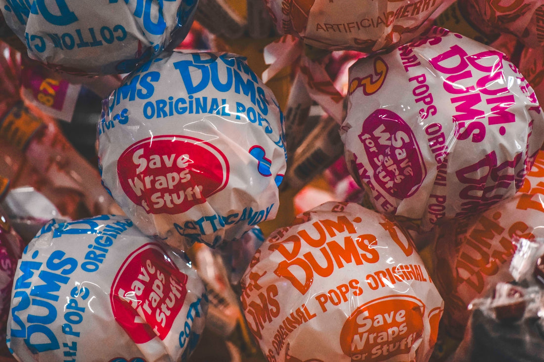 a pile of bags of dunkin'donuts sitting next to each other