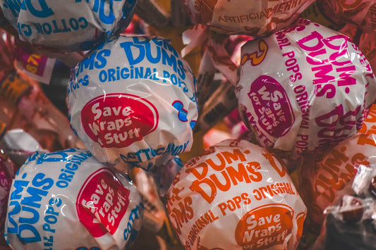 a pile of bags of dunkin'donuts sitting next to each other