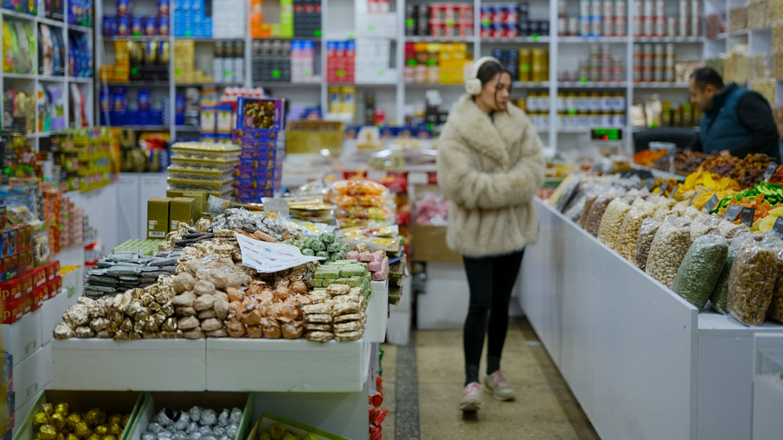 Woman browsing goods in a market stall.