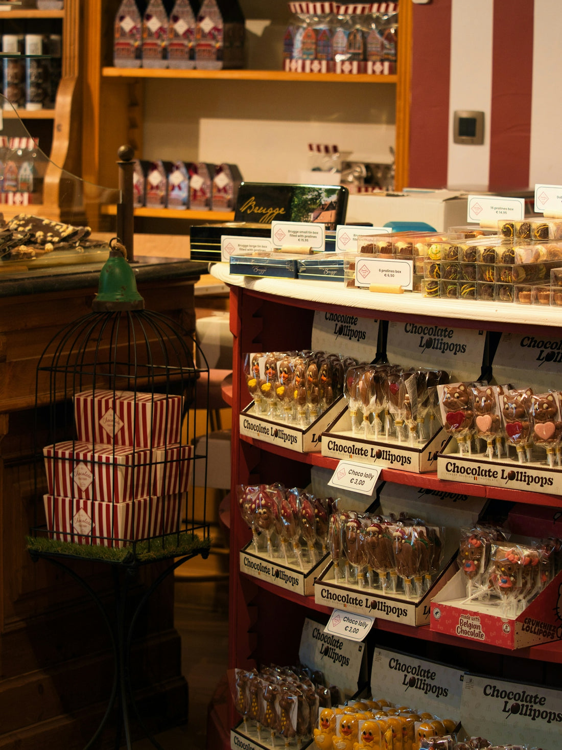 Chocolate lollipops displayed on shelves in a store.