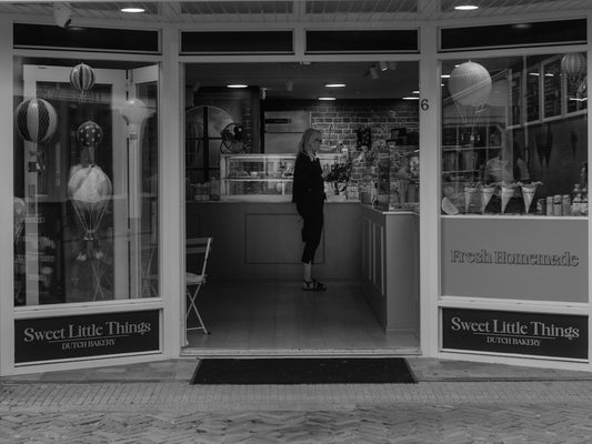 Woman standing in a sweet shop entrance