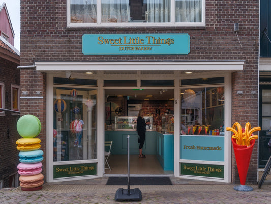 A bakery storefront with macarons and fries decorations