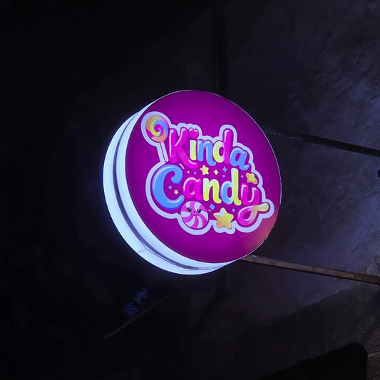 A bright, circular sign for kinda candy