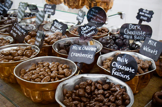 Bowls of assorted chocolate candies and nuts.