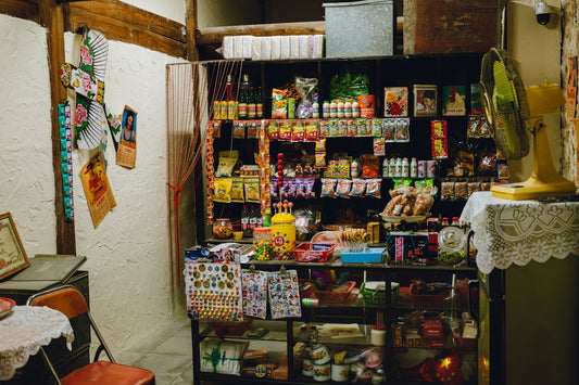 A traditional shop interior with shelves full of various products.